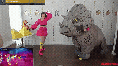 Woman In Triceratops Costume Dancing In Front Of Dynamite Twins Screen GIF