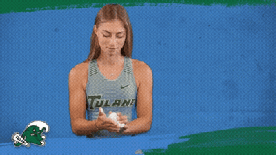 Woman In Tulane Tank Top Holding Something GIF