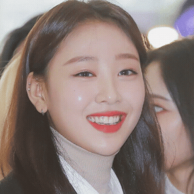 Woman In Turtleneck And Red Lipstick Smiling GIF
