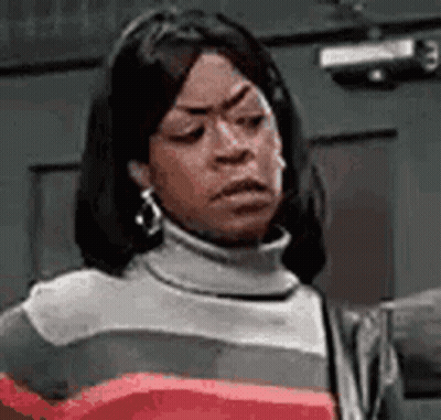 Woman In Turtleneck Making Funny Face GIF