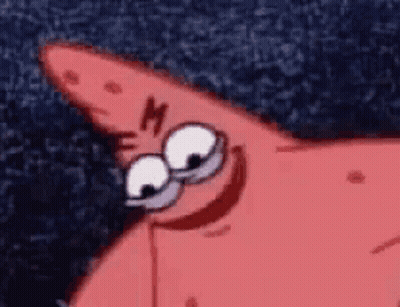Woman In Tuxedo And Turtleneck Sitting On Couch GIF