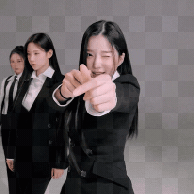 Woman In Tuxedo Pointing At Camera GIF