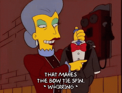 Woman In Tuxedo Says That Makes The Bow Tie Spin GIF