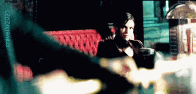 Woman in Tuxedo Sitting on Red Couch 2021