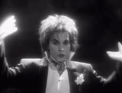 Woman In Tuxedo With Outstretched Hands GIF
