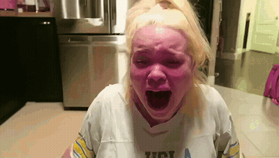 Woman In UCLA Shirt Screaming With Mouth Open GIF