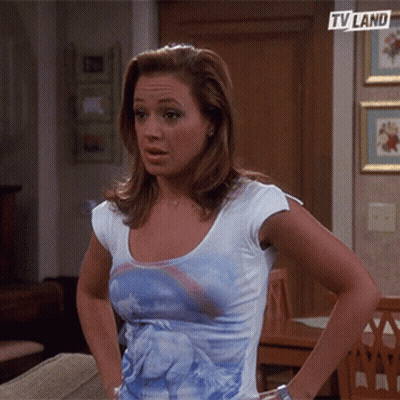 Woman In Unicorn T-Shirt In Front Of TV Land Sign GIF