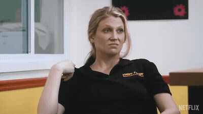 Woman In Valley Forge Shirt Sitting By Window GIF
