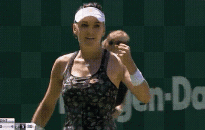 Woman In Visor And Black Tank Top In Front Of TMS Sign GIF