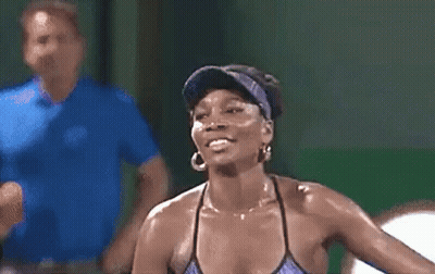 Woman In Visor And Earrings Smiling With Man Behind Her GIF