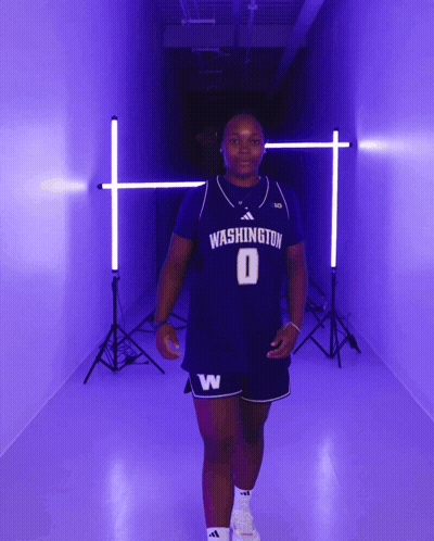 Woman In Washington Jersey Walking In Purple Hallway GIF
