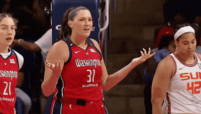 Woman in Washington Wizards Jersey Talking to Another Woman