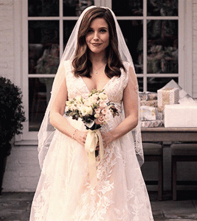 Woman In Wedding Dress Holding Bouquet GIF