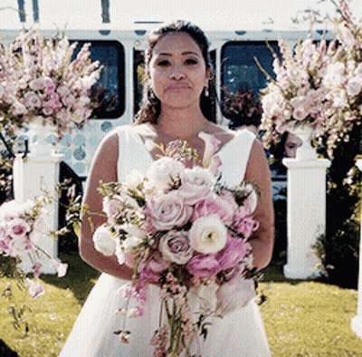 Woman In Wedding Dress Holding Pink Bouquet GIF