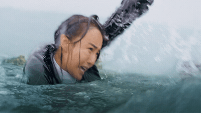 Woman In Wet Suit Pulled Out Of Water GIF