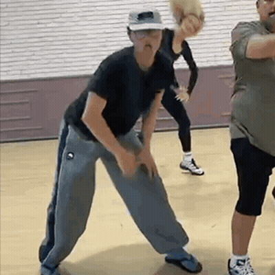 Woman In Wheelchair Dancing With Man In Front Of DWTS Sign GIF