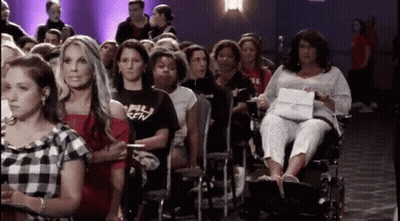 Woman In Wheelchair In Crowd GIF