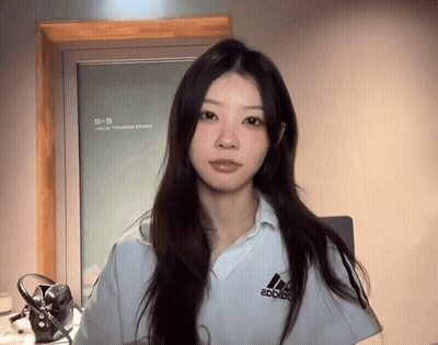 Woman in White Adidas Shirt in Front of Mirror