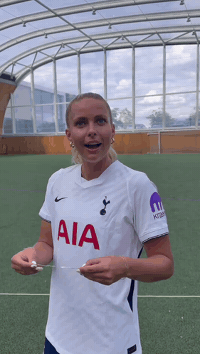Woman In White AIA Jersey Holding Paper GIF