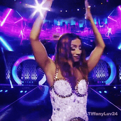 Woman In White And Gold Dress Dancing On Stage GIF