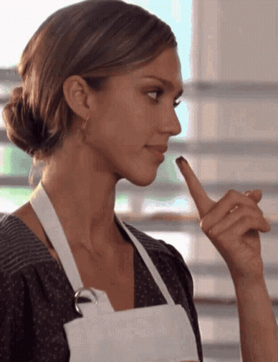 Woman In White Apron Holding Finger To Lips GIF