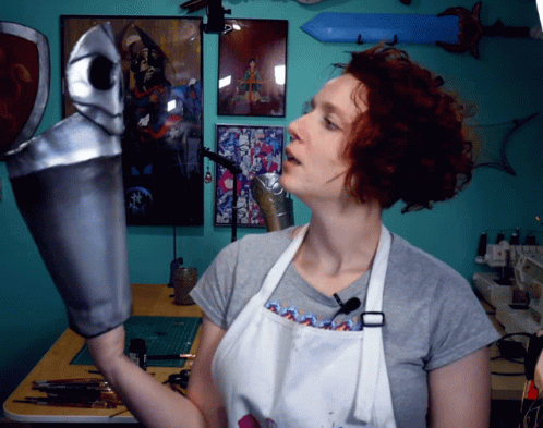 Woman In White Apron Holding Silver Object GIF