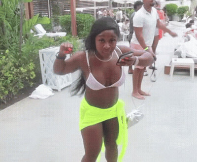Woman In White Bikini And Neon Green Shorts By Pool GIF