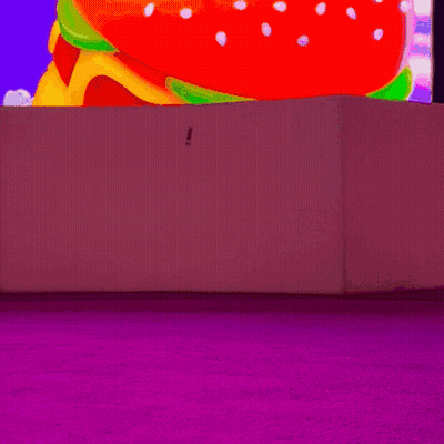 Woman In White Boots In Front Of Colorful Screen GIF