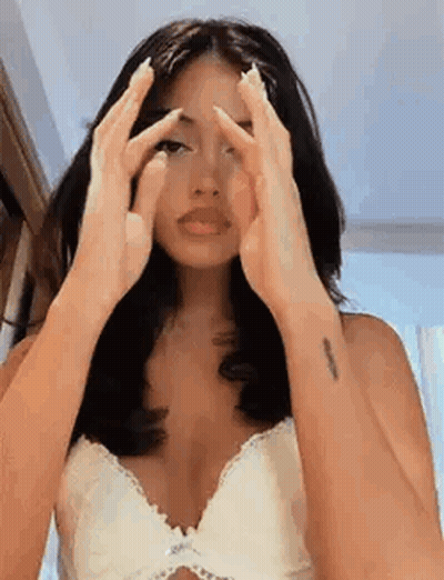 Woman In White Bra Covering Face With Hands GIF