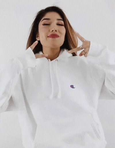 Woman In White Champion Hoodie Making Peace Sign GIF