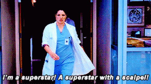 Woman In White Coat And Blue Scrubs Says I'm A Superstar GIF