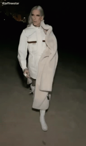 Woman In White Coat And Boots Walking GIF