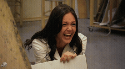 Woman In White Coat Laughing Holding Paper GIF