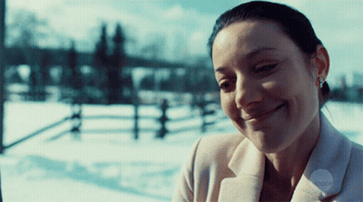Woman In White Coat Smiling In Snow GIF