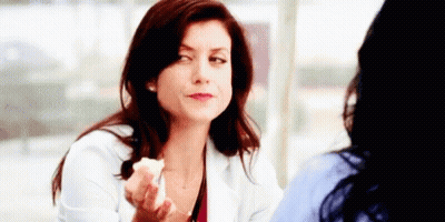 Woman In White Coat Talking To Another Woman Holding Food GIF
