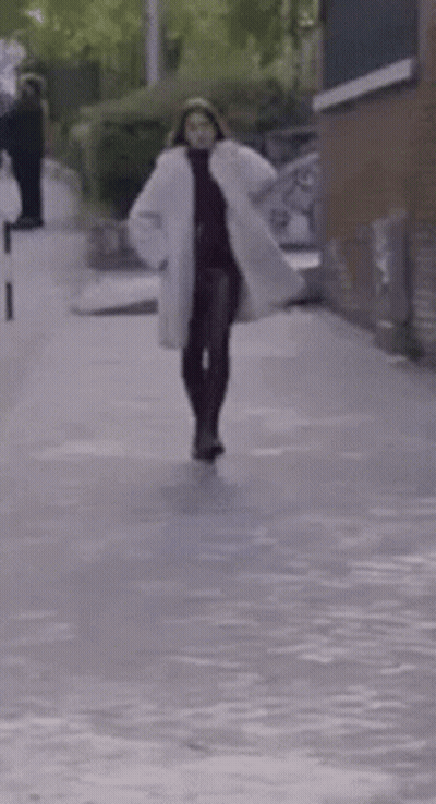 Woman In White Coat Walking GIF
