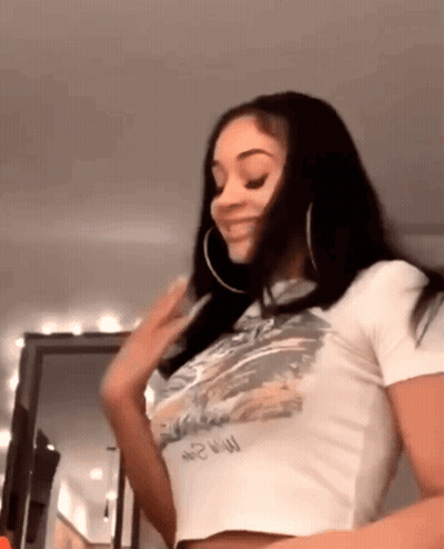 Woman In White Crop Top And Hoop Earrings GIF