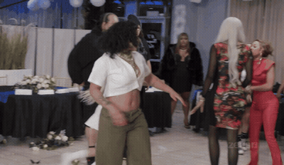 Woman In White Crop Top Dancing In Front Of Celebrity Sign GIF