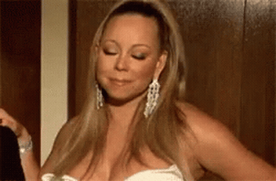 Woman In White Dress And Earrings Standing In Room GIF