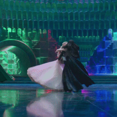 Woman In White Dress And Man In Black Cape Dancing GIF