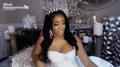 Woman In White Dress And Tiara With Real Housewives Sign GIF