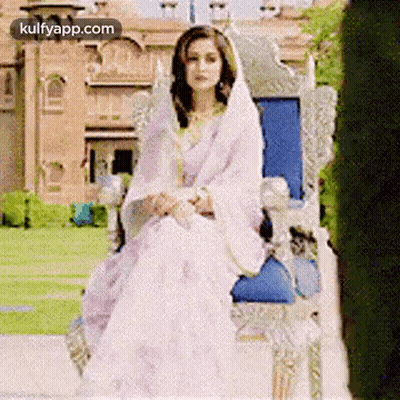 Woman In White Dress And Veil Sitting On Throne GIF
