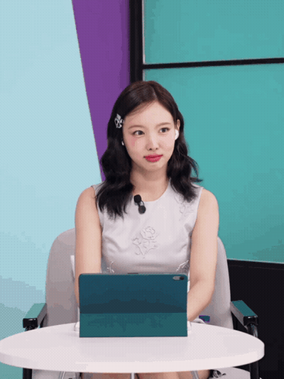 Woman In White Dress At Table With Tablet GIF