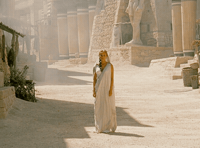 Woman In White Dress By Building GIF