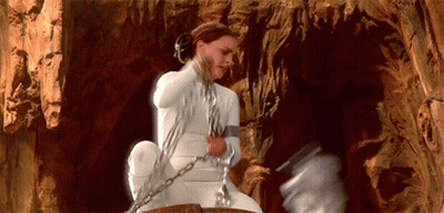 Woman In White Dress Chained To Rock GIF