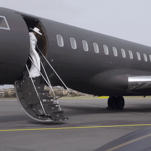 Woman In White Dress Climbing Airplane Stairs GIF