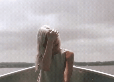 Woman In White Dress Covering Face In Boat GIF