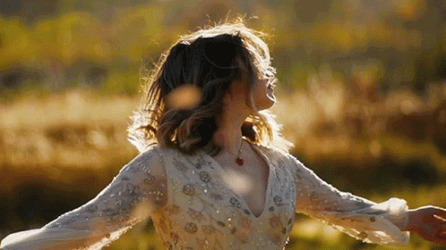 Woman In White Dress Dancing In Field GIF