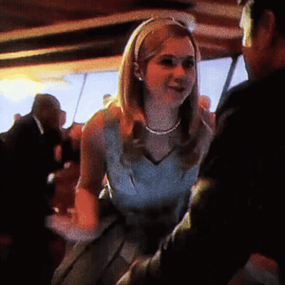 Woman In White Dress Dancing With Man In Black Suit GIF