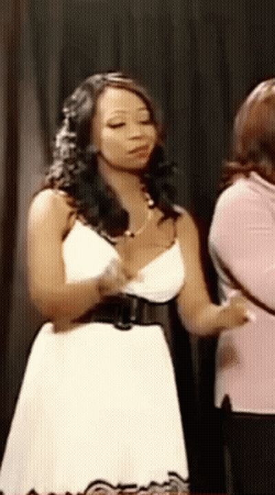 Woman In White Dress Holding Chest GIF